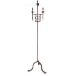 In the style of Gordon Russell Broadway wrought iron two branch candle stand , 175cm high