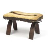 Stained wood camel stool with leathered cushion, 37cm H x 62cm W x 36cm D