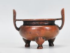 A 19th Century Chinese bronze censer ding bowl of small proportions raised on tripod stub feet