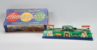 A mid 20th Century 1950's Russian tin plate clockwork toy with cars and buses circuiting through a