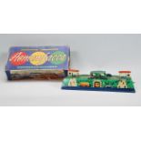 A mid 20th Century 1950's Russian tin plate clockwork toy with cars and buses circuiting through a