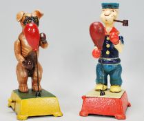 A pair of vintage style cast iron boxing figures in the form of popeye and a boxer dog having