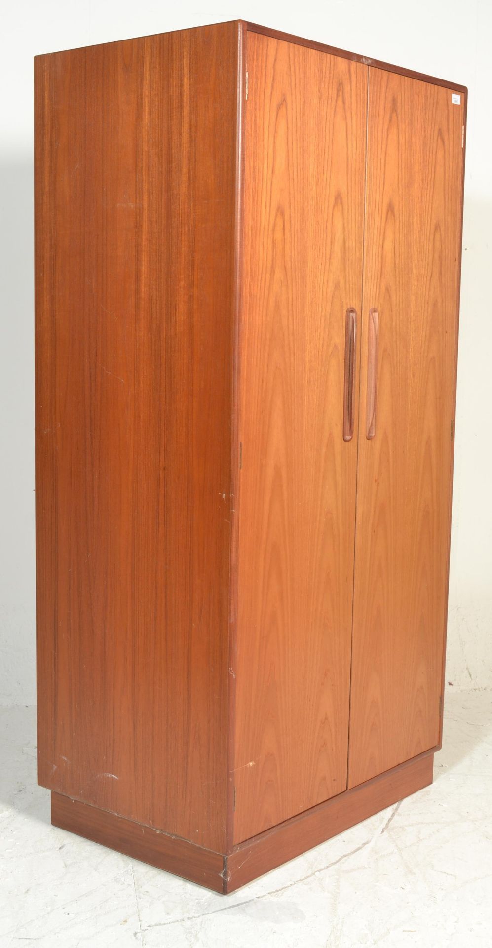 A vintage retro G Plan red label free standing wardrobe having twin doors with lipped and recessed