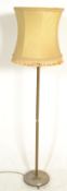 A 20th Century brass standard lamp being raised on a round base with three lions paw feet, with a