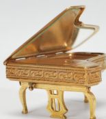 A vintage mid 20th Century ladies Pygmalion compact in the form of a piano, having articulated