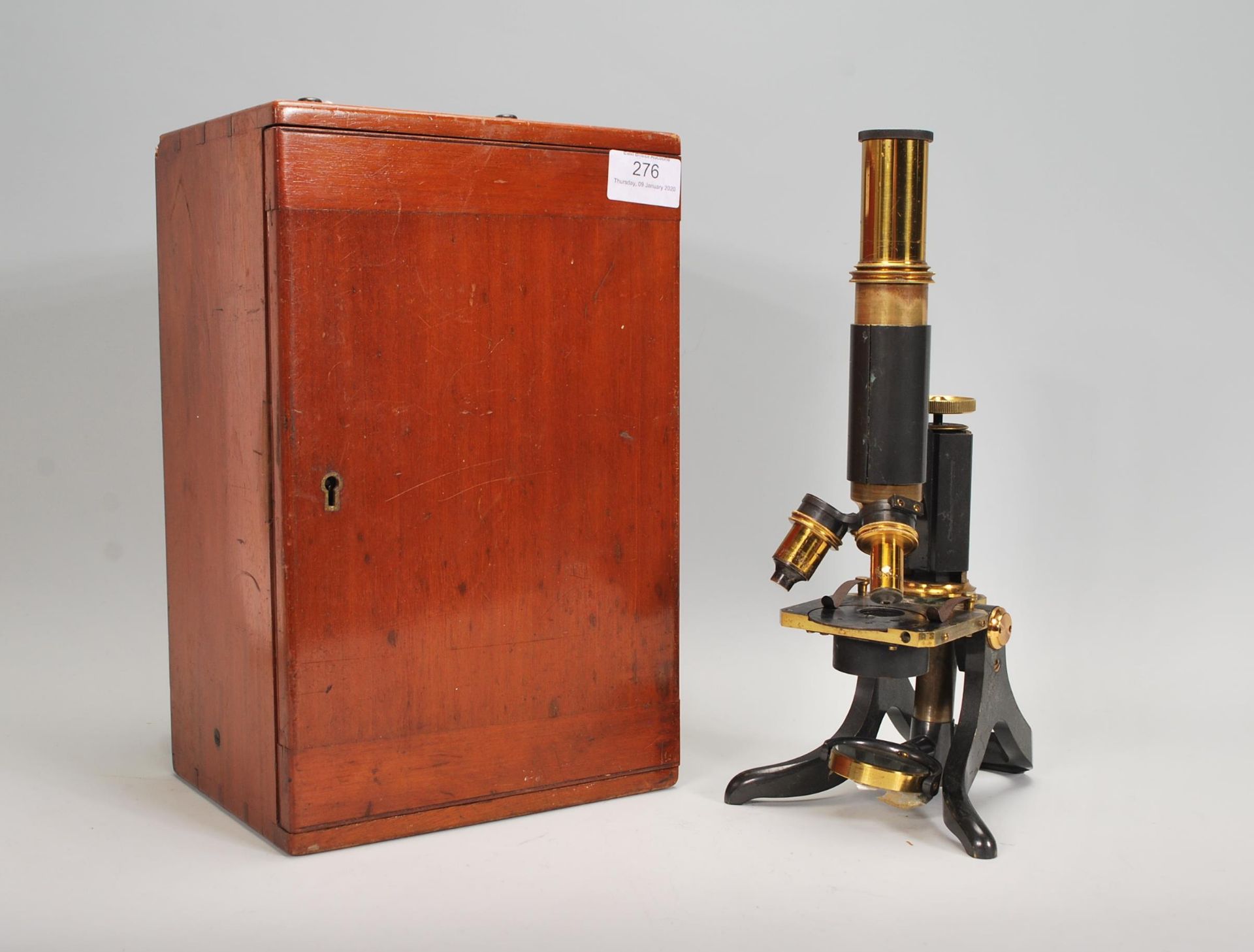 A late 19th early 20th Century J. Swift and Son, black japanned and lacquered brass microscope and