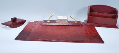 A good quality mid century leather desk set comprising a desk pad with inset paper, pen stand and