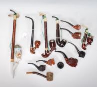 A collection of vintage smoking pipes to include English and continental examples, some porcelain,