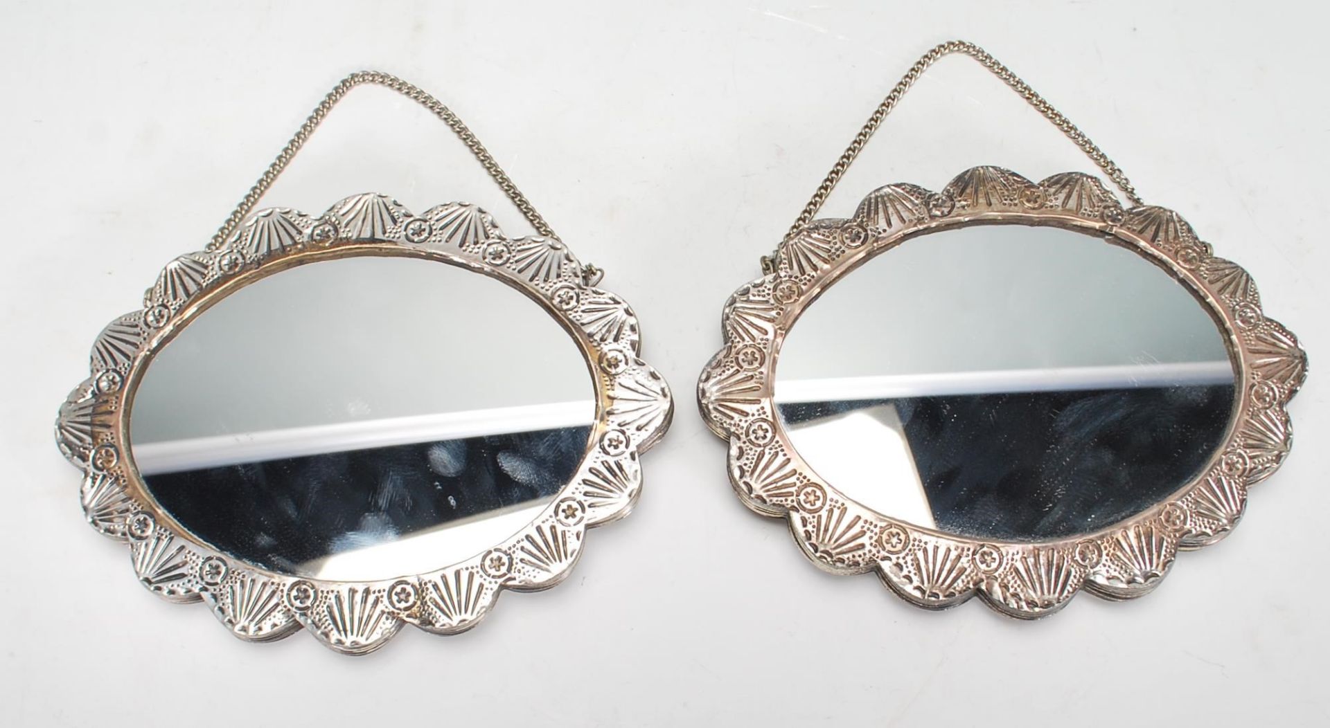 A pair of 20th Century 900 silver small wall hanging / dressing table mirrors of oval form, silver