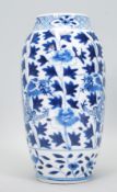 An early 20th Century Chinese blue and white vase of tapering form with two dragons amongst