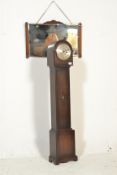 An early 20th Century Art Deco oak cased grandmother clock of typical form together with an Art Deco