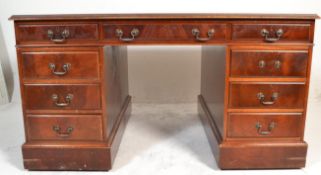A Victorian style mahogany and leather twin pedestal Partners desk having tooled green leather inset