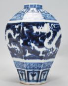 A 19th Century Chinese earthenware vase of tapering octagonal bulbous form hand painted in blue