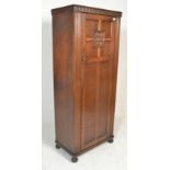 A 20th Century oak bachelors sentry box wardrobe in the manner of Jaycee / Old Charm, single panel