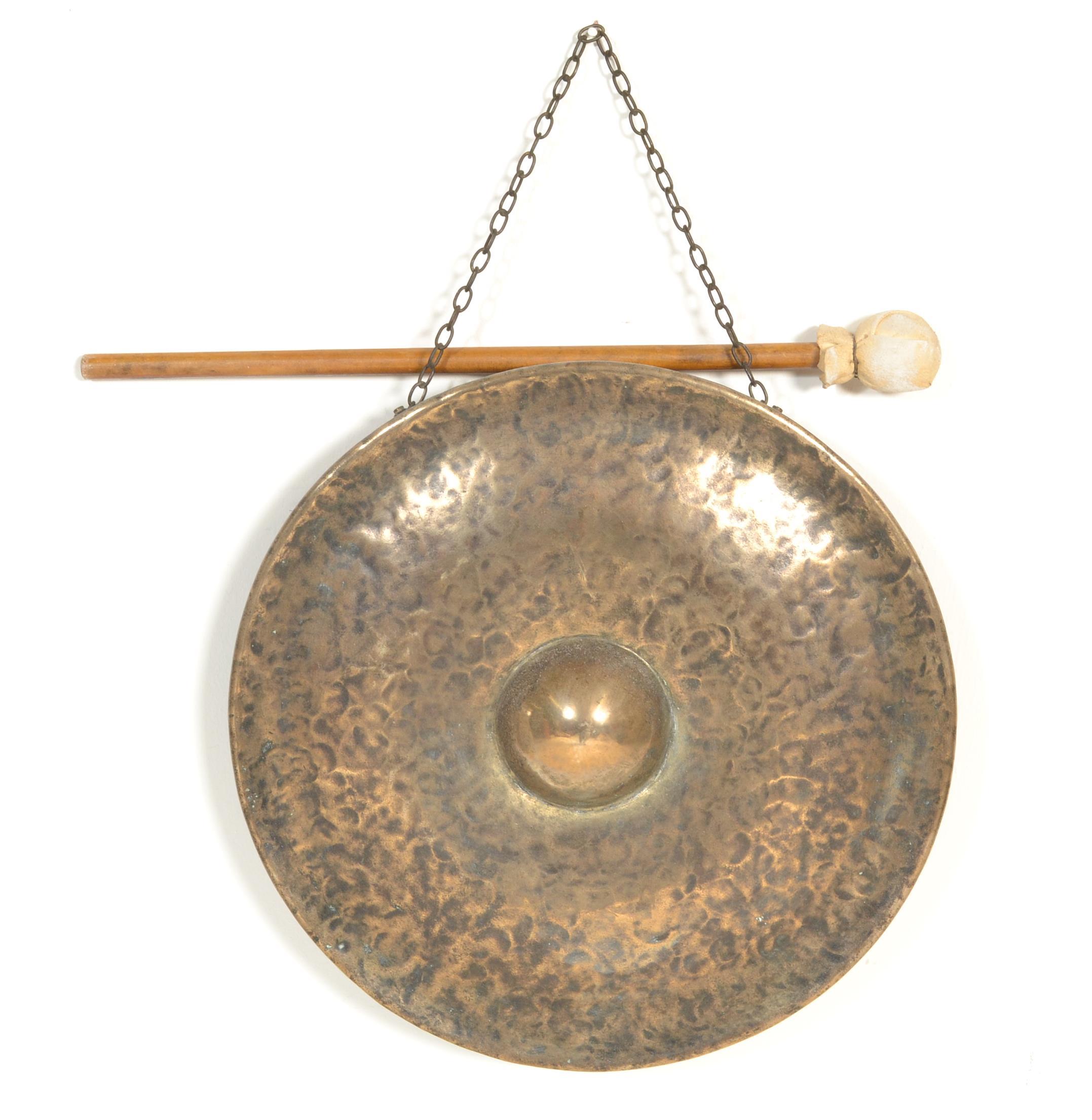 A large early 20th century planished brass gong of roundel form together with the associated