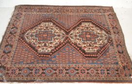 A large Islamic Persian woollen floor rug carpet on red and blue ground, two central medallion