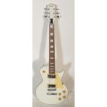 A Swift made six string Gibson Les Paul style electric guitar having a white body with cream pick
