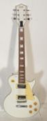 A Swift made six string Gibson Les Paul style electric guitar having a white body with cream pick