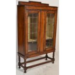 A 1920's oak barley twist shipping oak twin door bookcase / china display cabinet. Raised on
