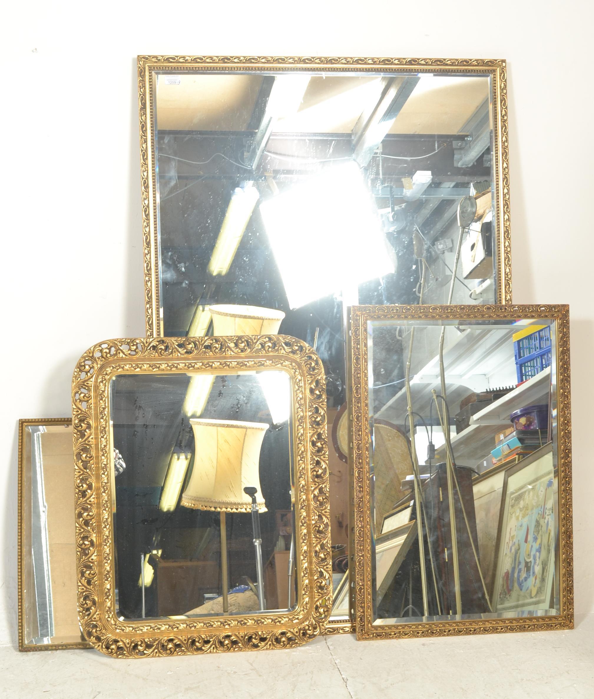 A group of contemporary antique style wall mirrors, each with gilt frames and of varying sizes.