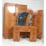A 1930's Art Deco walnut bedroom suite comprising a drop centre walnut dressing table with good