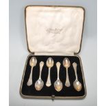 A cased set of of silver hallmarked coffee spoons having shaped handles with rat tail detailing to