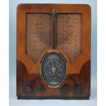 A 1930's Art Deco walnut two tone 4 valve radio. Of upright form having decorative walnut two tone