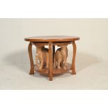 A 20th Century walnut coffee table nest of oval form raised on shaped supports having four