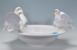 A 20th Century Italian ceramic bird bath centrepiece having a white footed bowl with perched doves