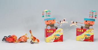 A group of vintage Chinese tin plate and plastic clockwork toys to include 2 Goose driving horse