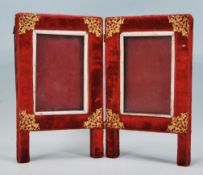 A 19th Century Victorian red velvet folding photo frame raised on square supports having