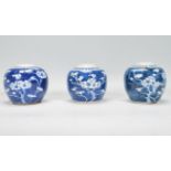 A group of three Chinese blue and white ginger jars of bulbous form and small proportions being hand