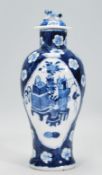 A Chinese blue and white lidded baluster vase having a fu dog finial top being hand painted in the