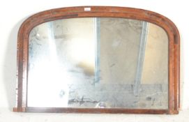 A Victorian 19th century overmantel mirror. Set within an inlaid walnut cushion style frame with