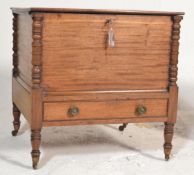 A 19th century William IV mahogany work box / commode. Raised on turned legs with castors having