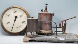 A vintage scratchbuilt copper distillery with pipes mounted on a wooden metal lined base together