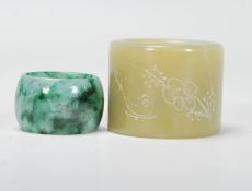 A 20th Century Chinese large green jade archer's thumb ring of cylindrical form having engraved