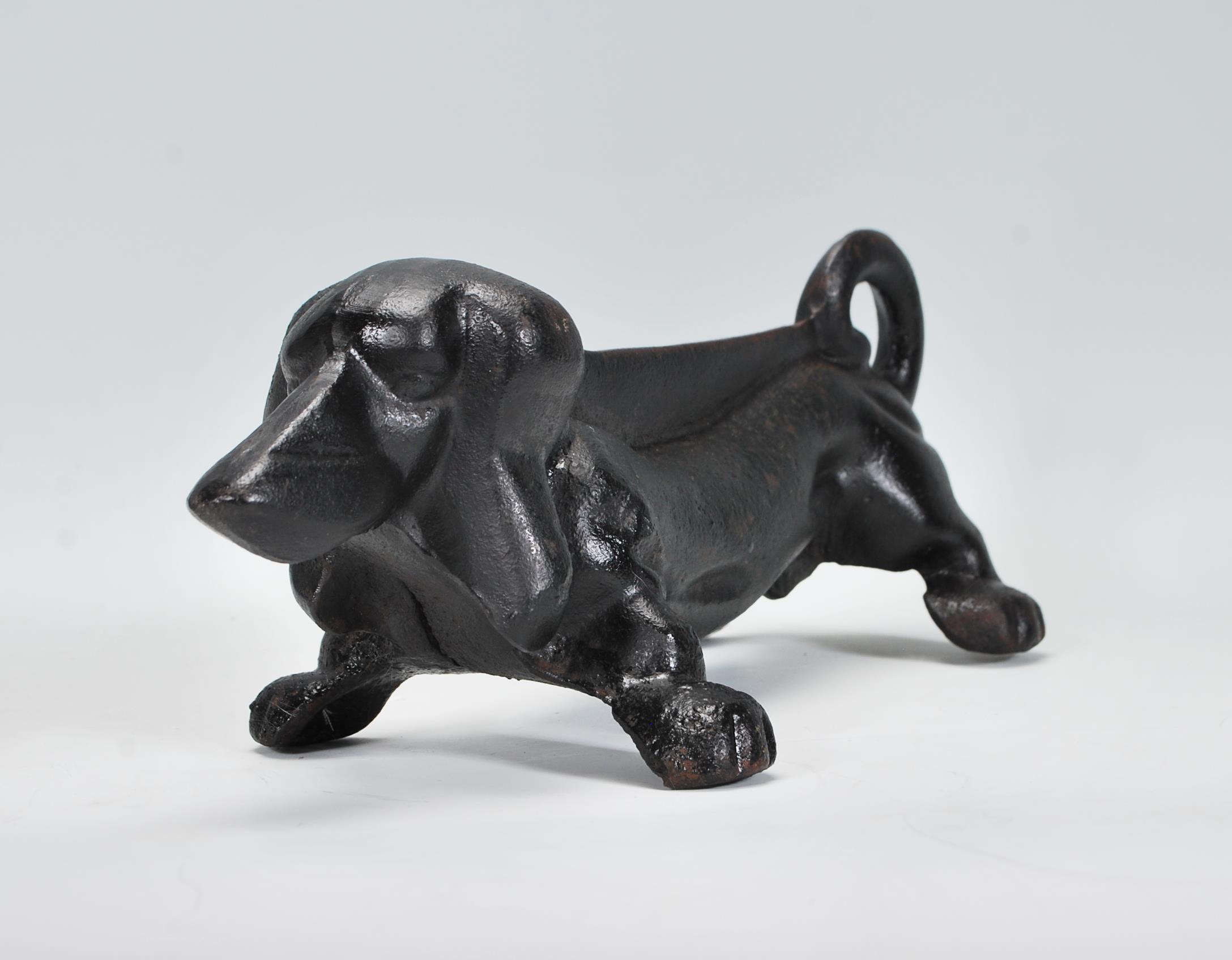 A 20th Century cast iron boot scraper scrape in the form of a Dachshund dog, finished in black paint
