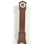 An early 20th century mahogany granddaughter clock with silvered circular dial, Arabic chapter ring,