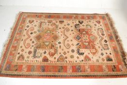 A 20th Century Persian Islamic floor Kabir carpet rug having a beige ground with a red border having
