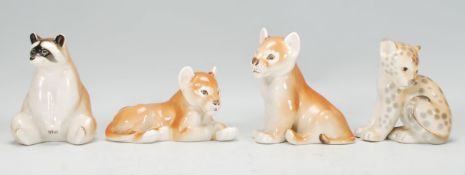 A group of four vintage mid Century USSR ceramic figures to include two lion cubs, a raccoon and