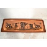 A large mid century African copper panel in relief depicting elephants on the plain bearing