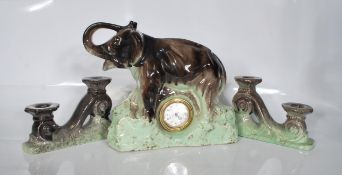 An early 20th Century Art Deco 1930's French 3 piece ceramic clock garniture set. The clock itself