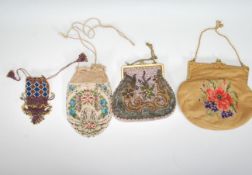 A group of vintage 20th Century evening handbags to include a tapestry bag decorated with a flower