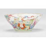 A 20th Century Chinese famille rose porcelain bowl being hand painted with immortals, depicting 18