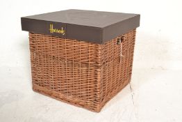 A Harrods food/ picnic hamper having a square wicker basket base with a leatherette fitted lid