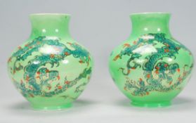 A pair of vintage 20th Century lustre Royal Art Pottery vases having light green ground with twin