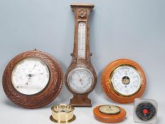 A mixed collection of varying barometers dating from the early 20th Century to include a round oak