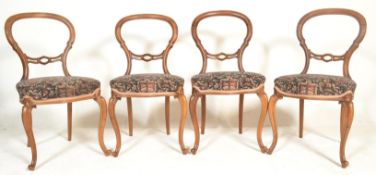 A set of 4 Victorian 19th century mahogany balloon back dining chairs. Raised on serpentine carved
