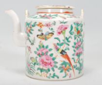 A 19th Century Chinese Canton famille rose teapot of cylindrical form having hand enamelled floral